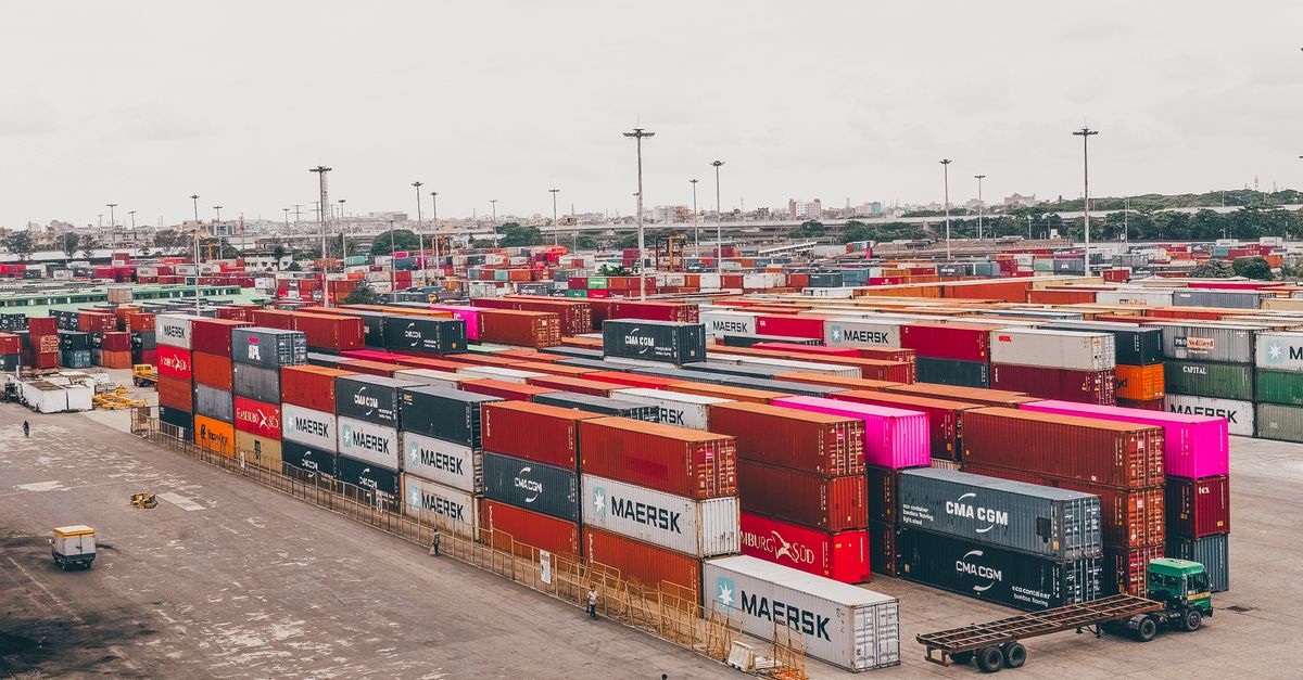 Colorful shipping containers stacked at a bustling port showcasing global trade.